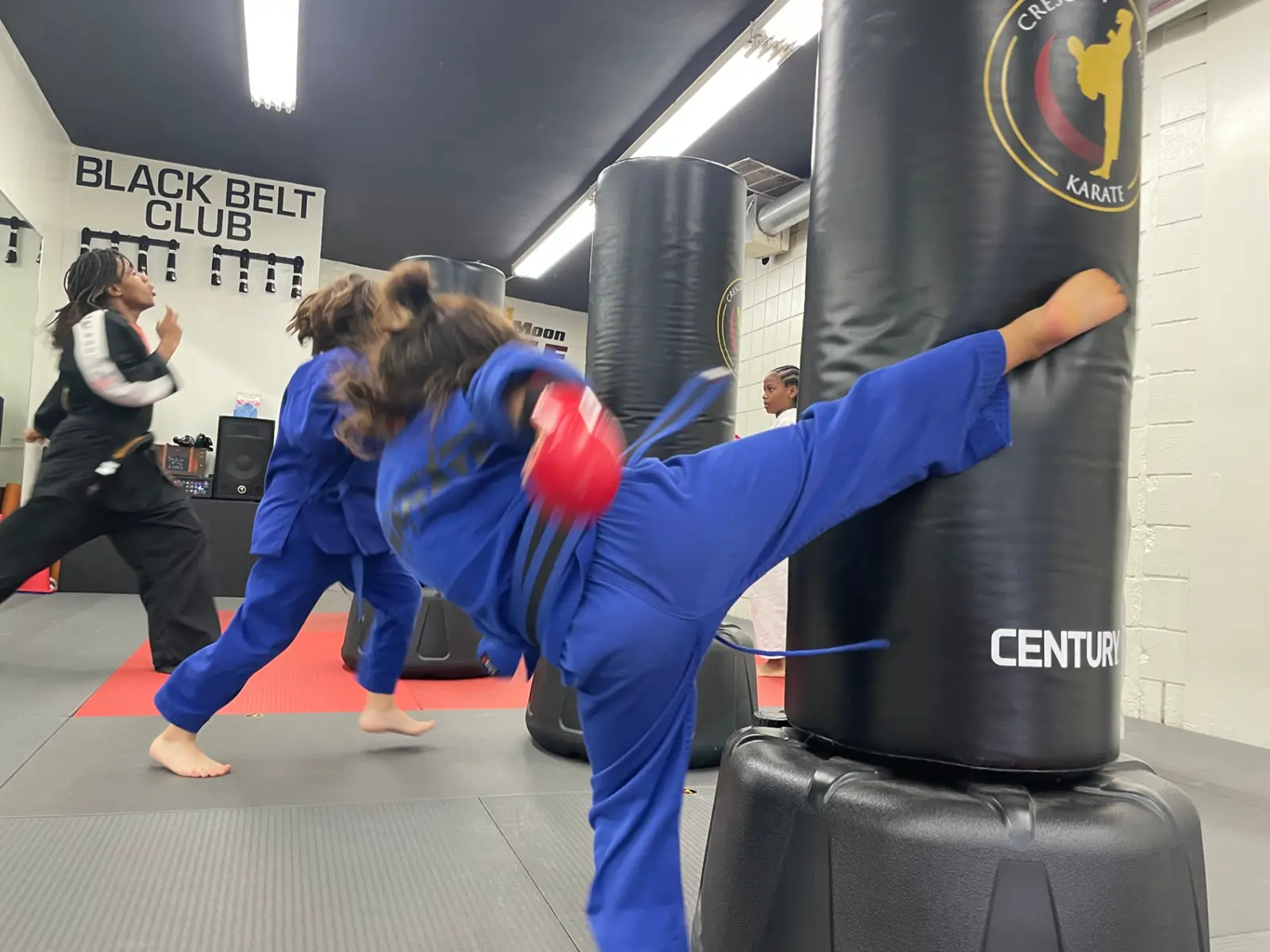 A student kicks a training bag