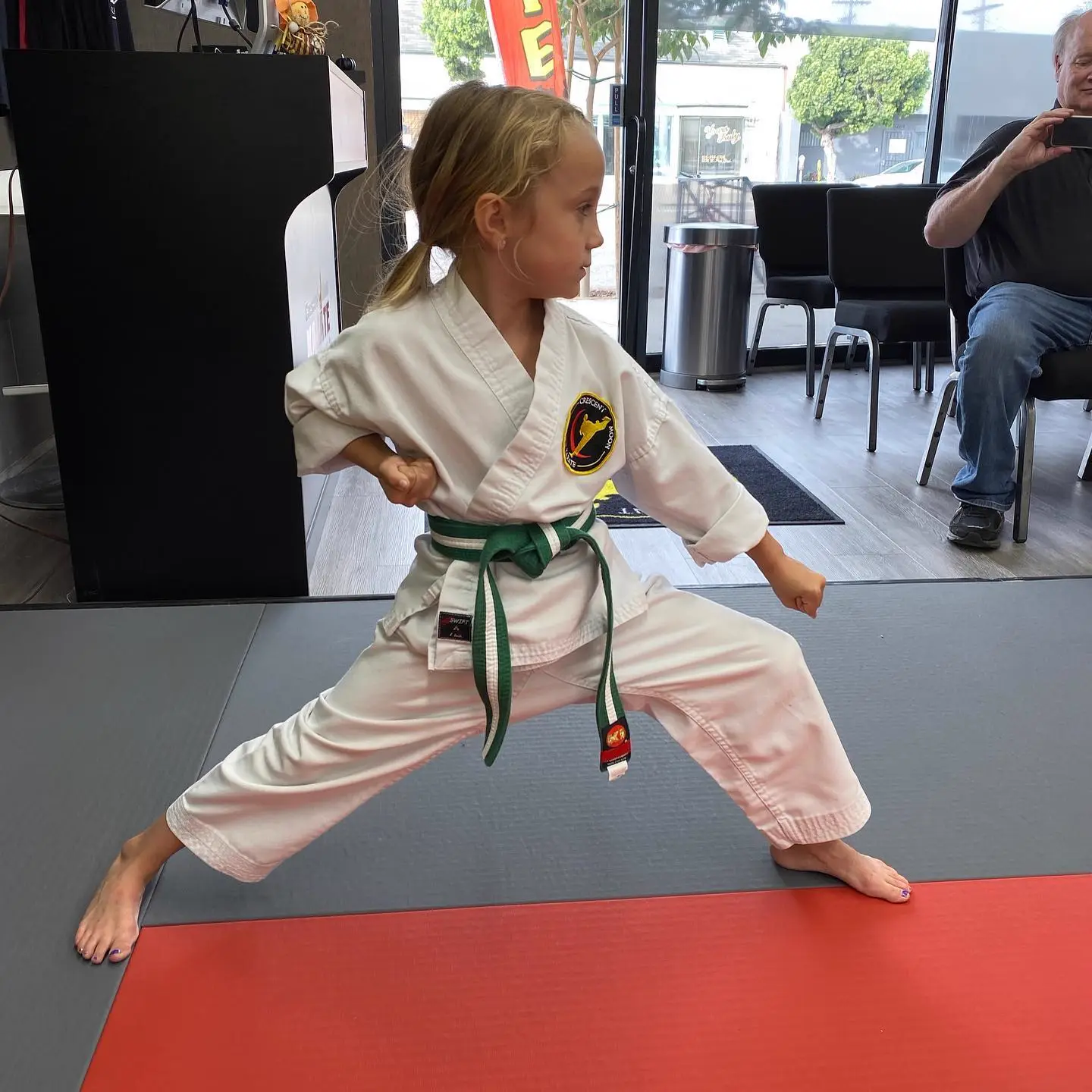 A young student holds her stance